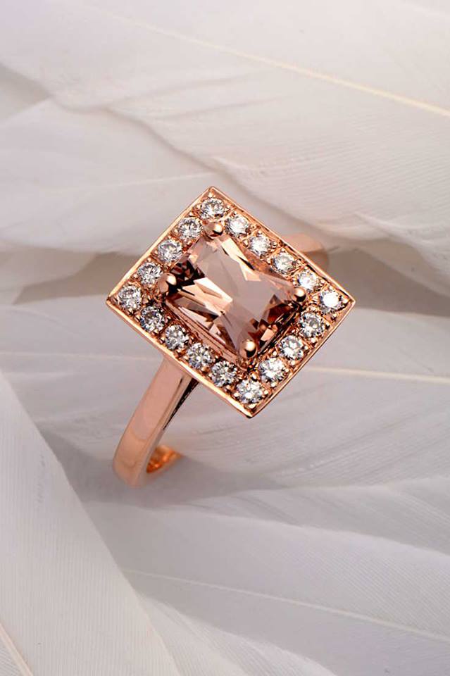 one-of-a-kind bespoke rose gold halo ring with a large rectangular morganite surrounded by white diamonds on a white feather background from jewellery designer Christine Sadler