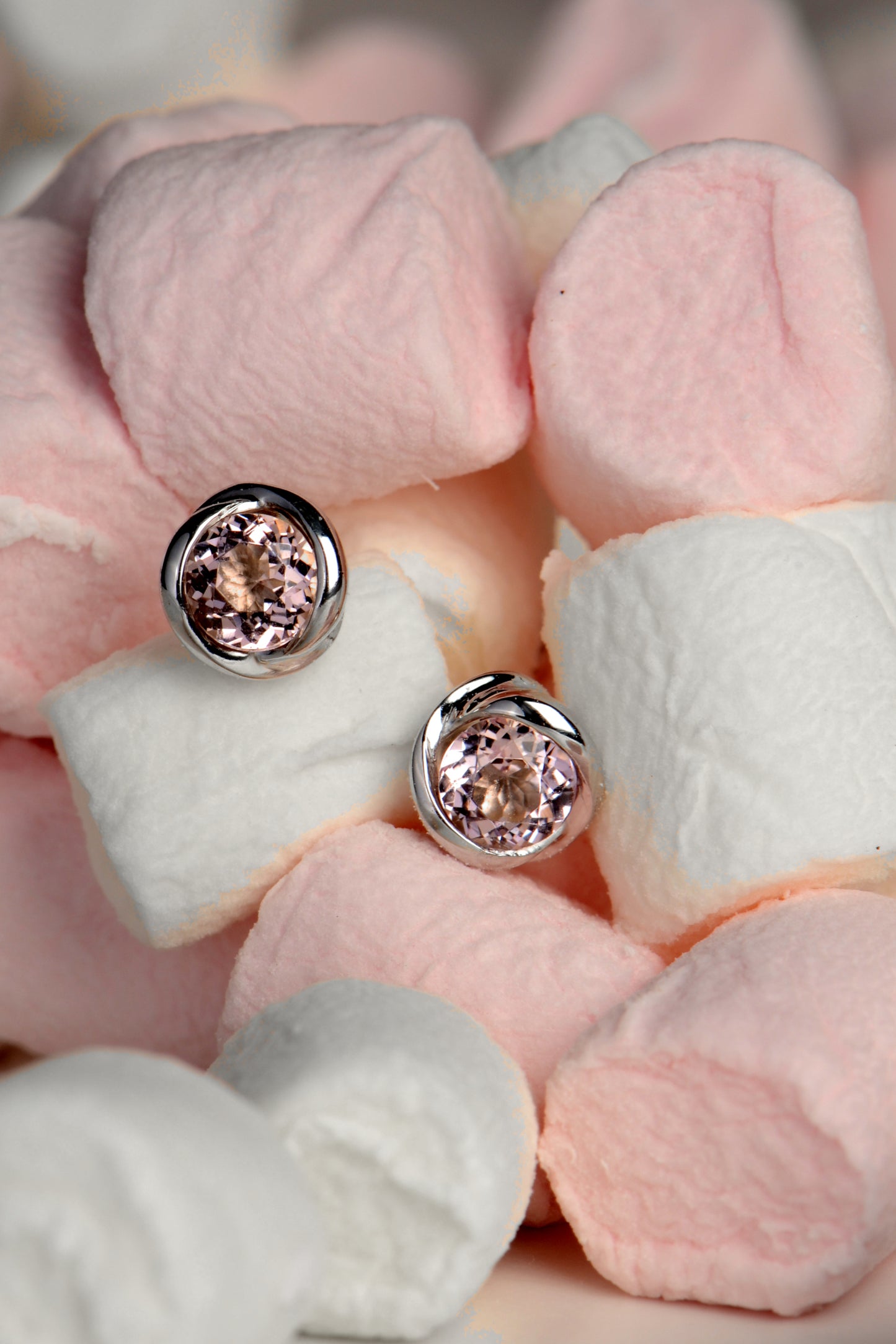 a pair of morganite earrings in a pile of pink and white marshmallows