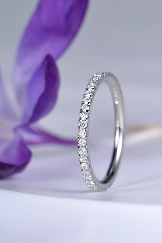 narrow diamond wedding ring in platinum with diamonds all the way round, sometimes called a full eternity ring