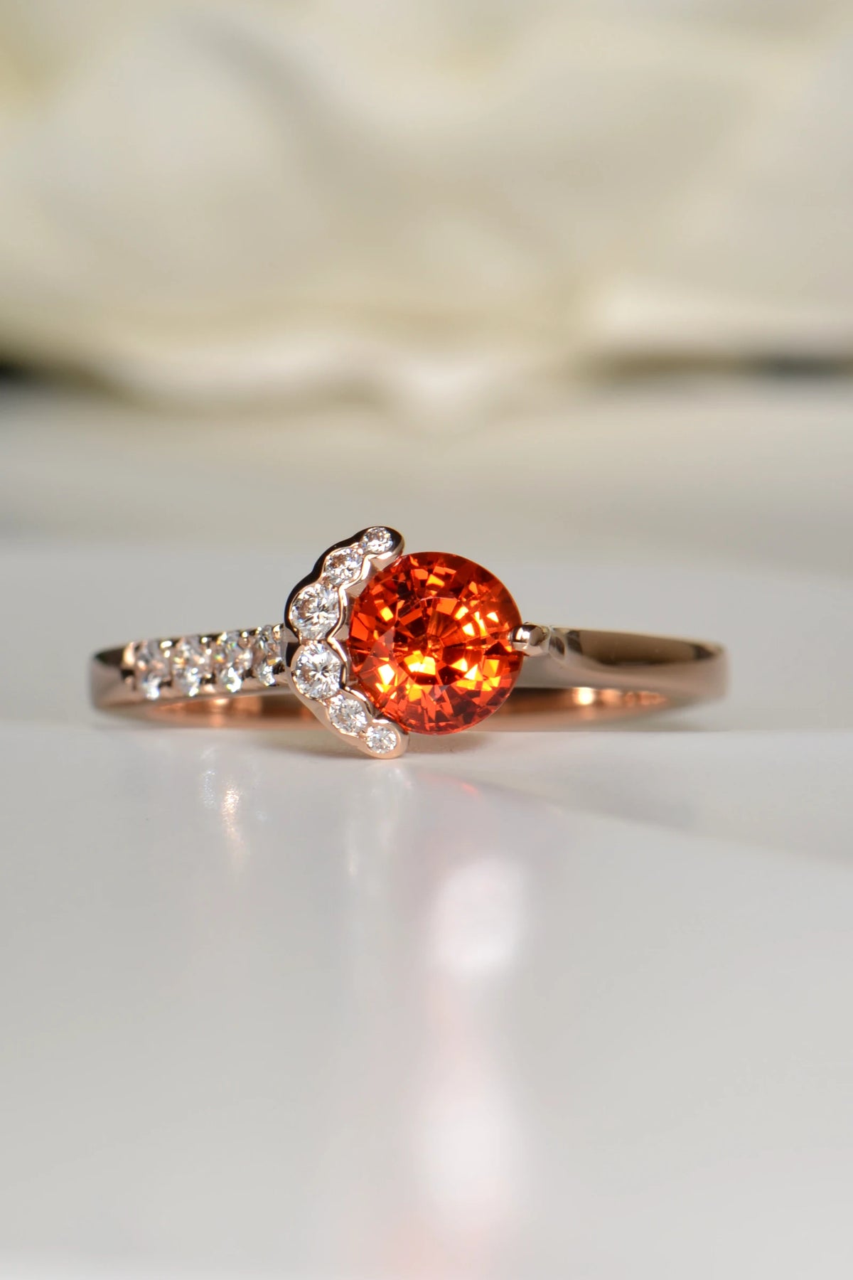 Fairypools orange sapphire ring in 18ct rose gold with diamond crescent, front view.