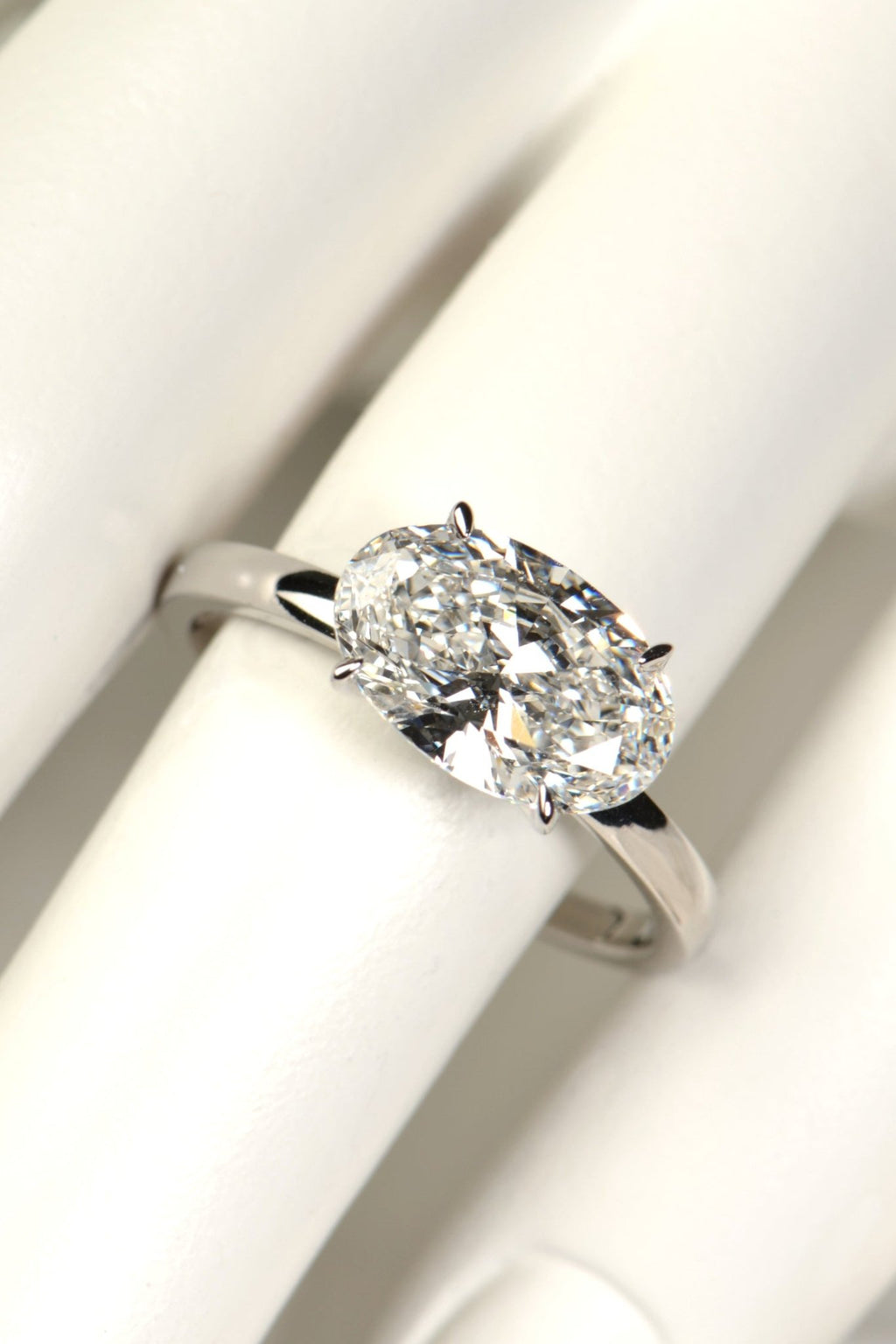 Platinum 3 carat east–west oval lab-grown diamond ring on mannequin hand, crafted in Britain with sustainable luxury design