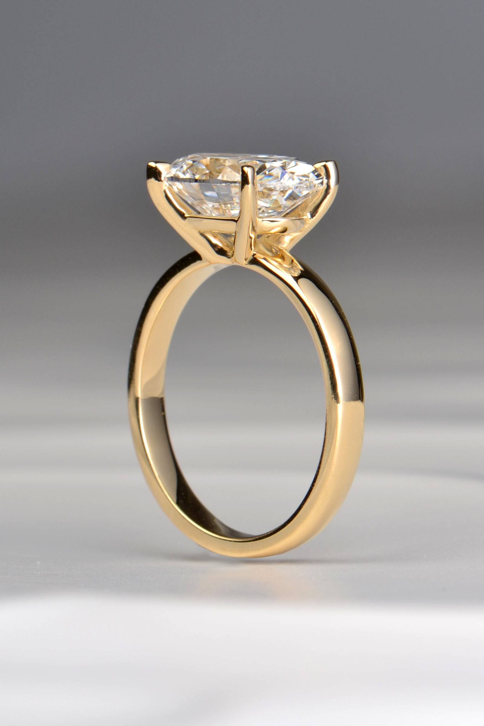 3ct oval lab grown diamond engagement ring in 18ct yellow gold showing the elegant four clau setting - Christine Sadler