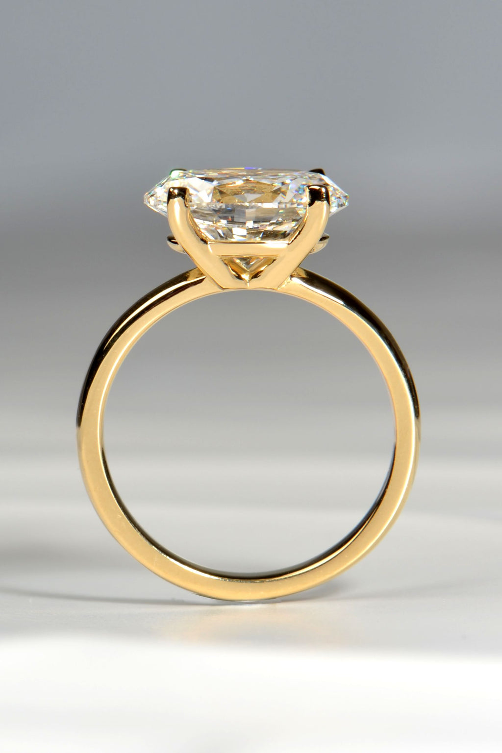 gold engagement ring 3ct oval cut lab diamond side view showing the four claw east west setting - Christine Sadler