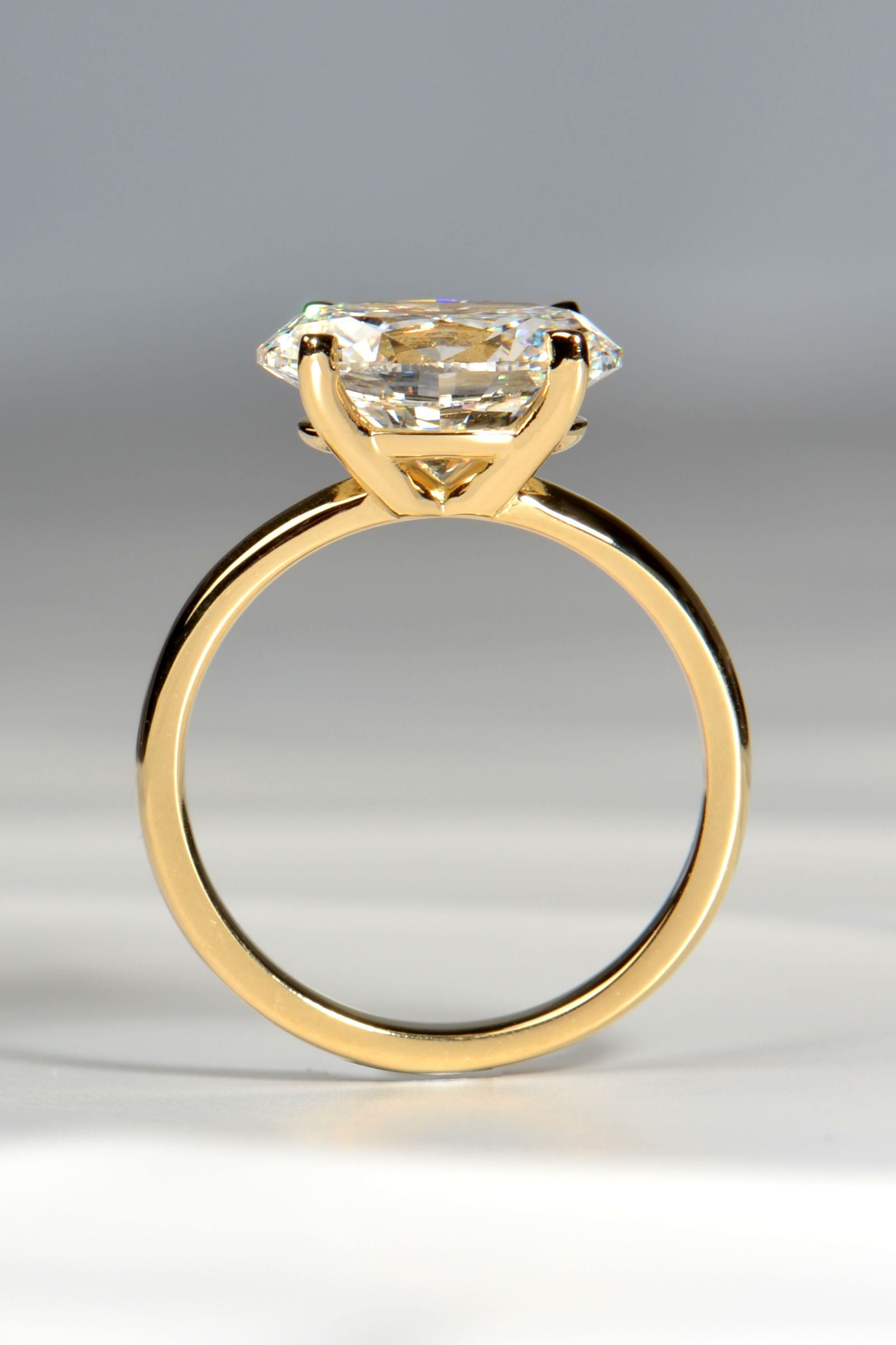 gold engagement ring 3ct oval cut lab diamond side view showing the four claw east west setting - Christine Sadler