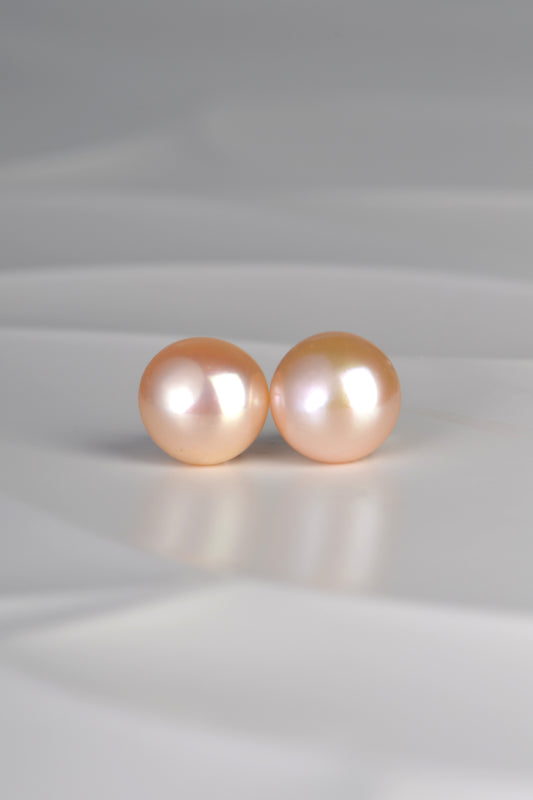 a large pair of real cultured pearl earrings  in a soft peach colour