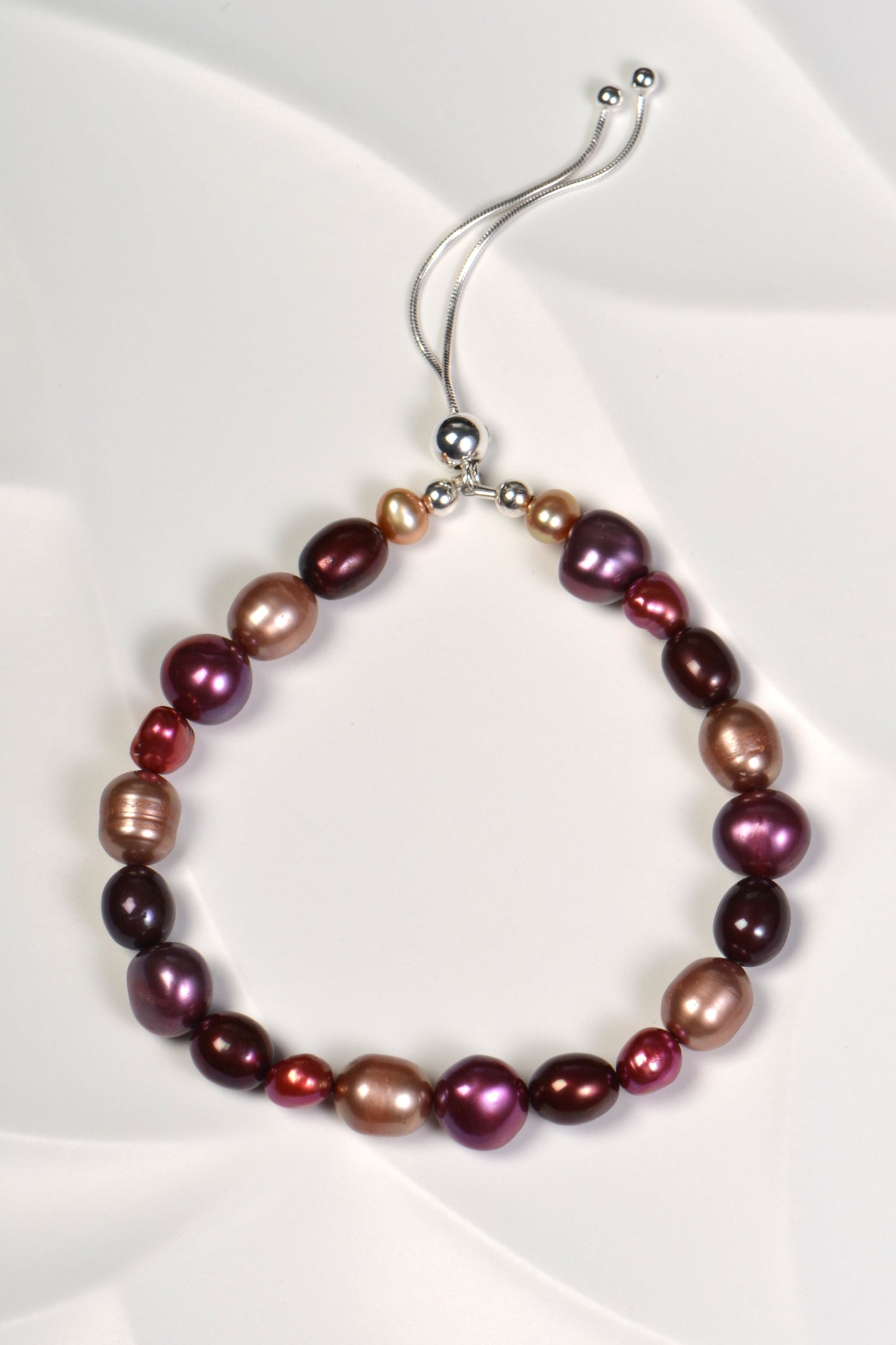 multicoloured real pearl bracelet in red, purple and pale brown