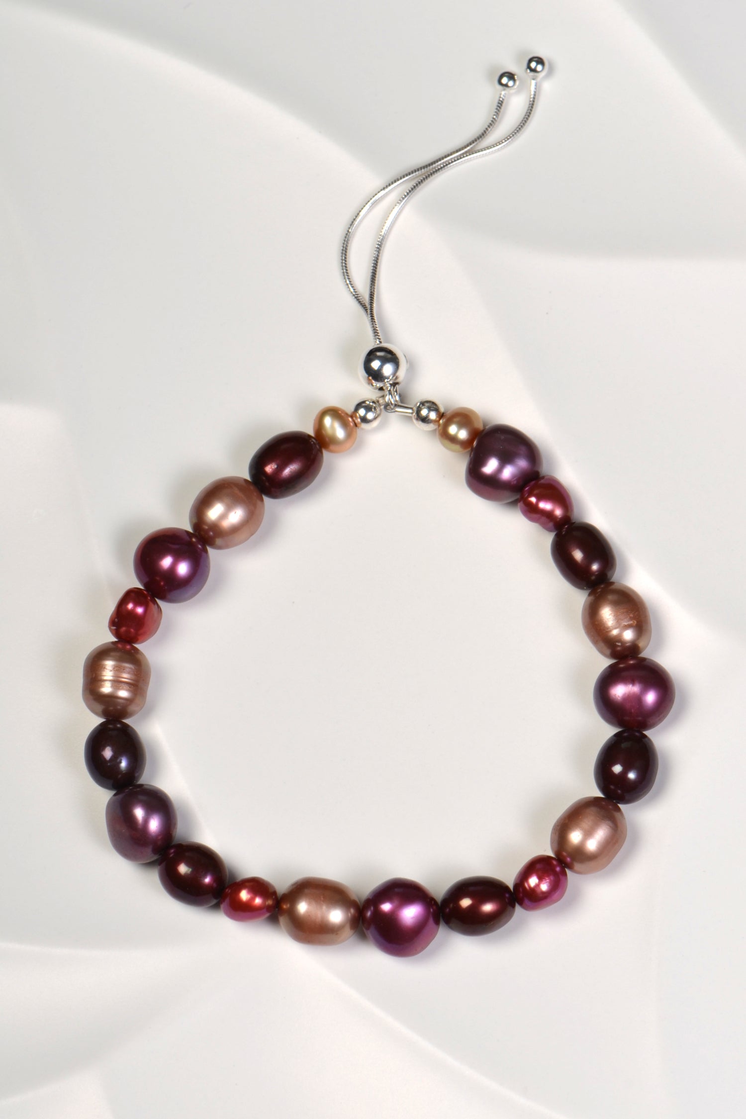 multicoloured real pearl bracelet in red, purple and pale brown