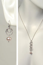 Handmade cultured pink pearl necklace and earring set with interlocking sterling silver circle design on a maequin to show size and scale