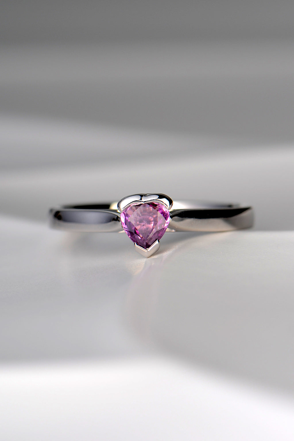 white gold ring with heart shaped pink sapphire in centre