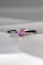 white gold ring with heart shaped pink sapphire in centre