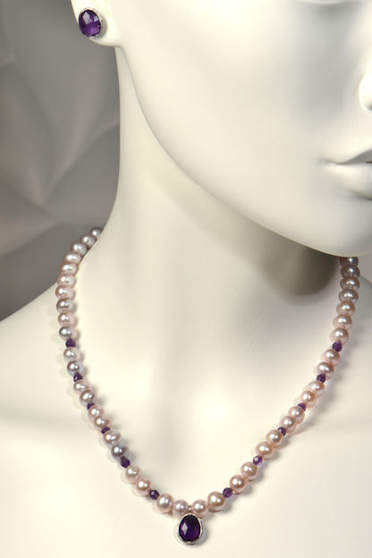 Pink cultured pearl necklace with amethysts on a mannequin with matching amethyst stud earrings