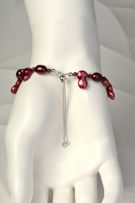 red pearl bracelet with slider clasp that makes this bracelet adjustable in size