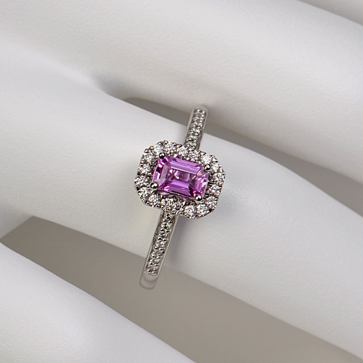 platinum halo ring set with a strong pink sapphire and diamonds Christine Sadler bespoke engagement ring