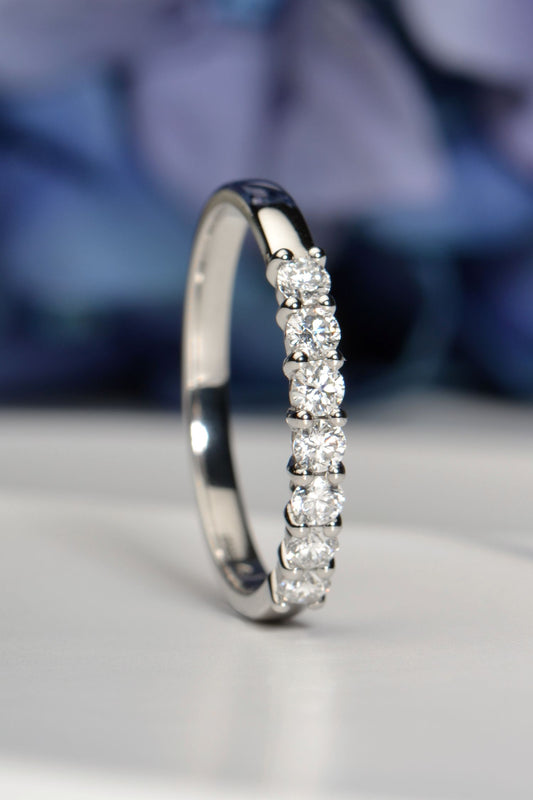 British handmade 7-stone half carat diamond ring, claw-set, worn on hand, lab-grown diamonds