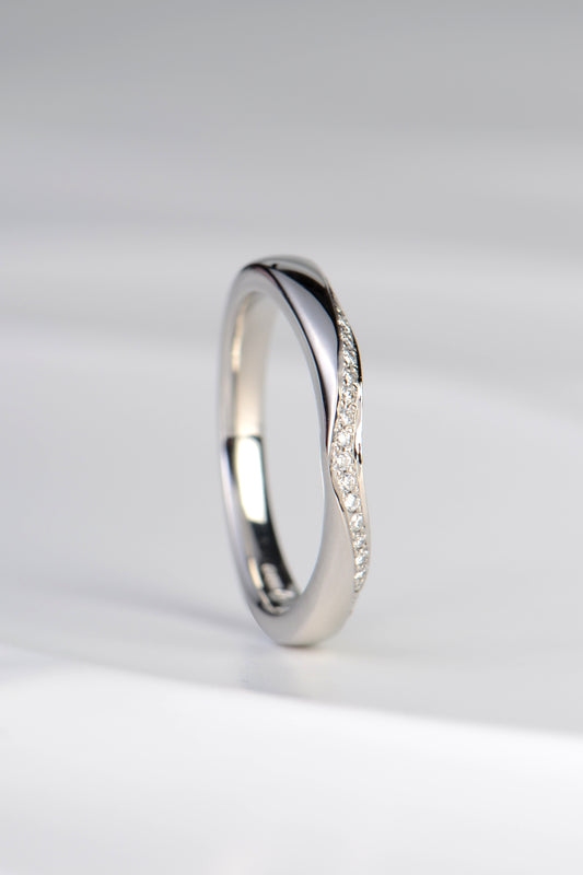 stunning U shaped wedding ring to sit next to an engagement ring with a ribbon of diamonds along one edge