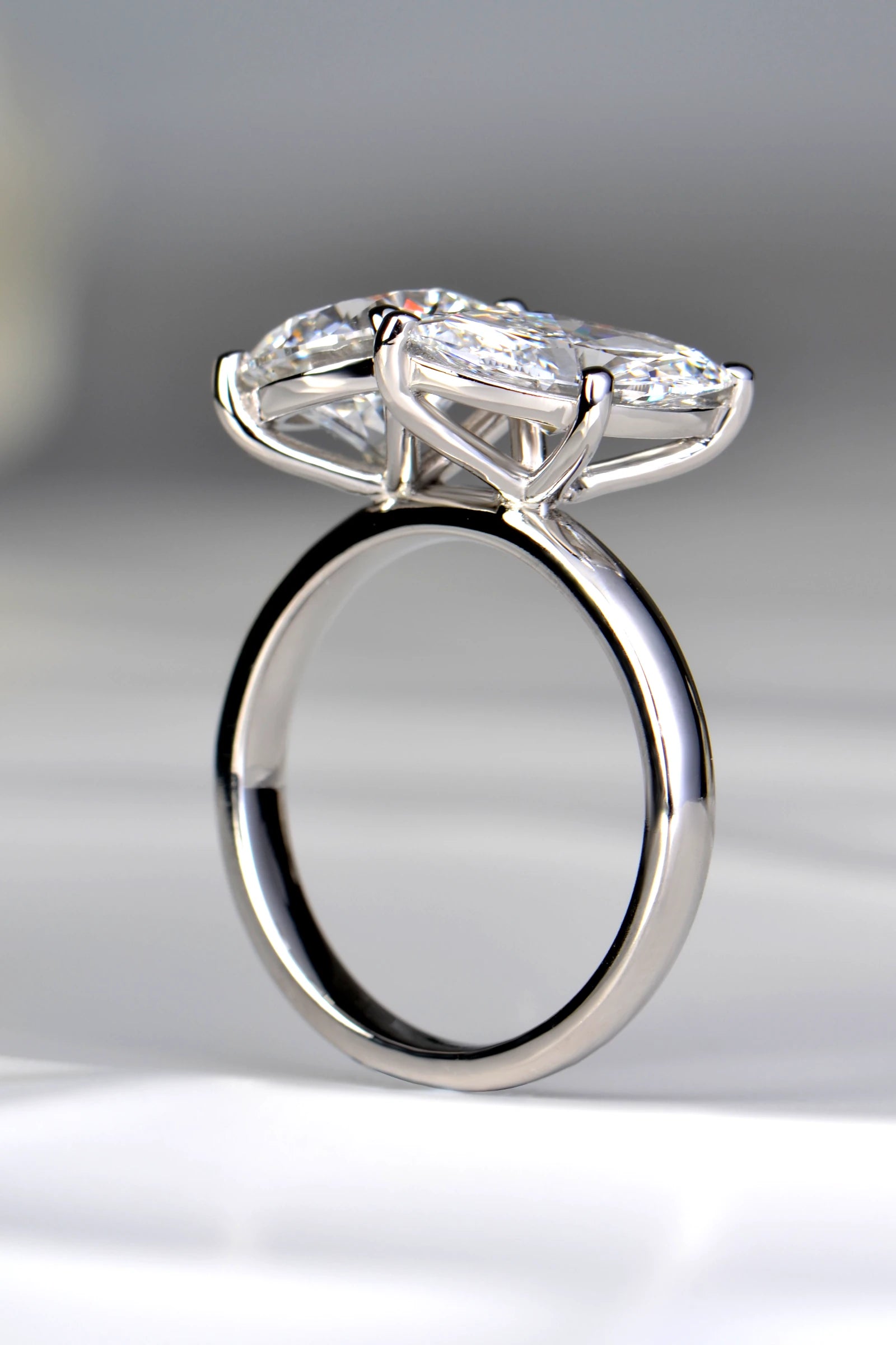 Three-quarter perspective of a handcrafted two-stone lab diamond ring showcasing the continuous uniform depth of the platinum shank by Christine Sadler