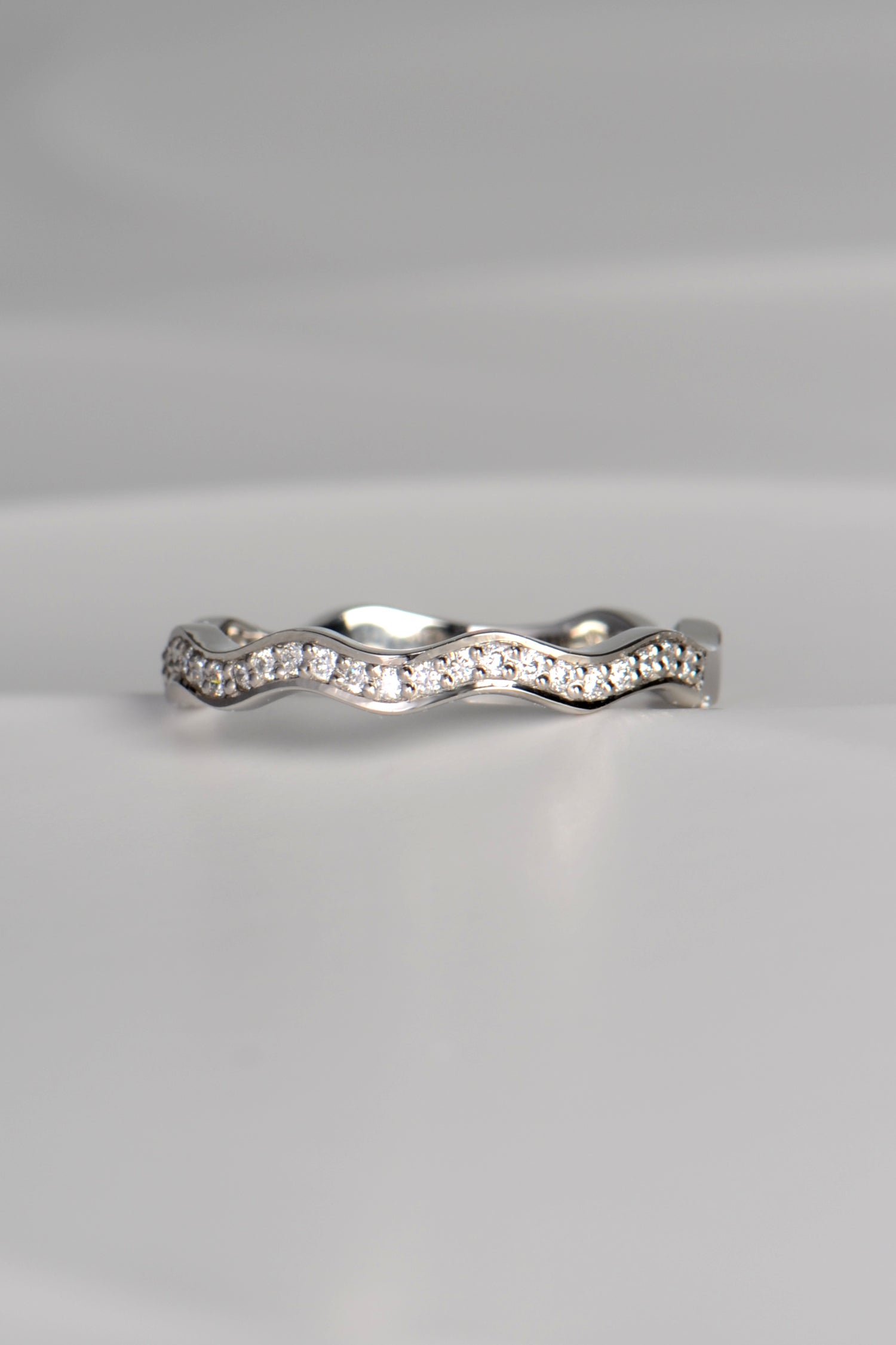 narrow platinum diamond set wavy ring made in the UK