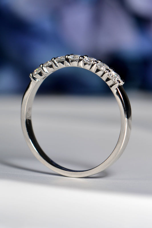 Side view of British handmade 7-stone platinum ring, claw-set diamonds, highlighting band craftsmanship and detail