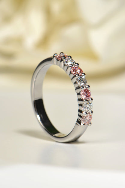 Angled view of platinum seven-stone ring showing claw settings and sparkling lab diamonds