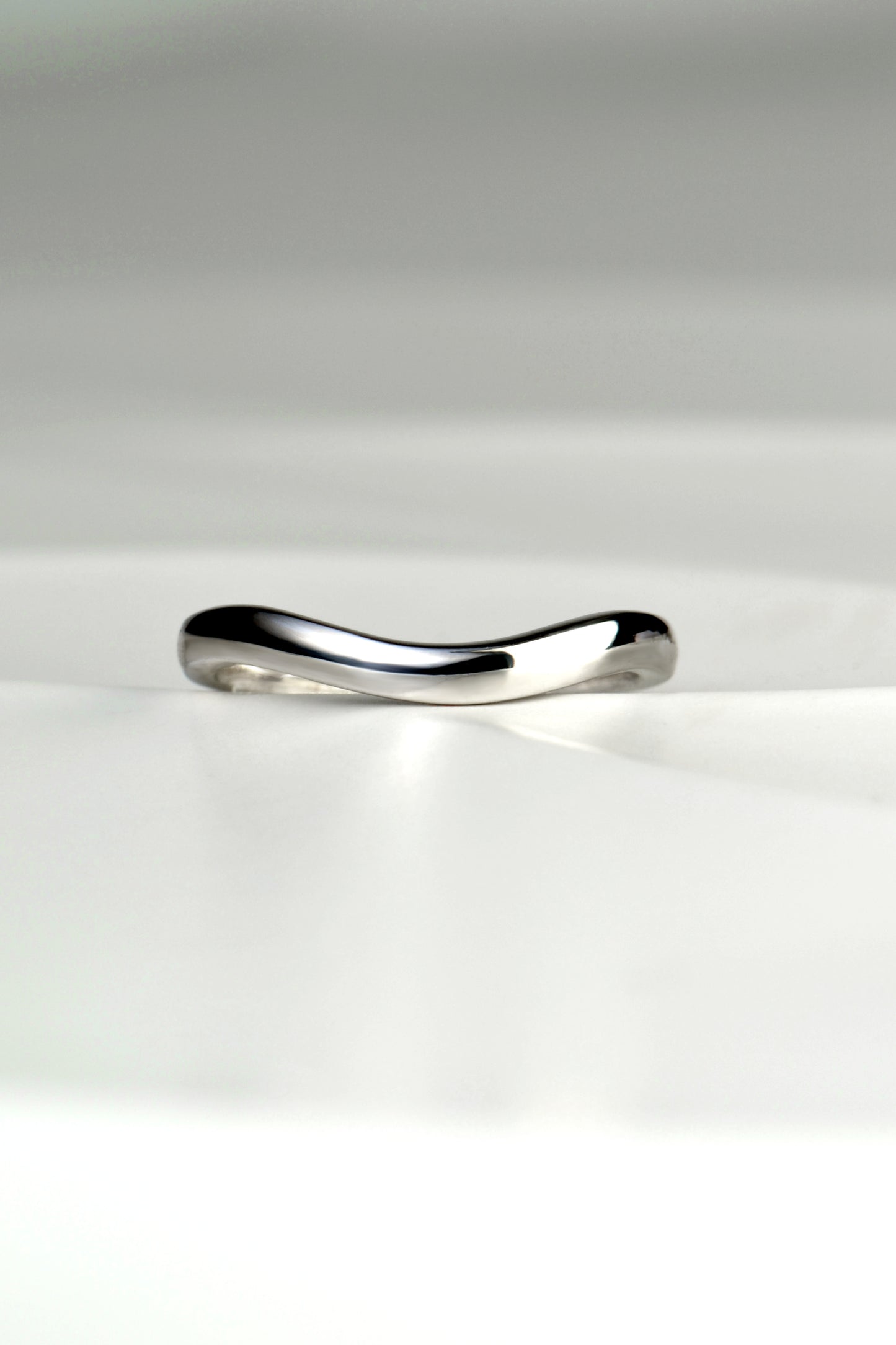 Platinum wedding ring with slight curve to fit next to engagement ring