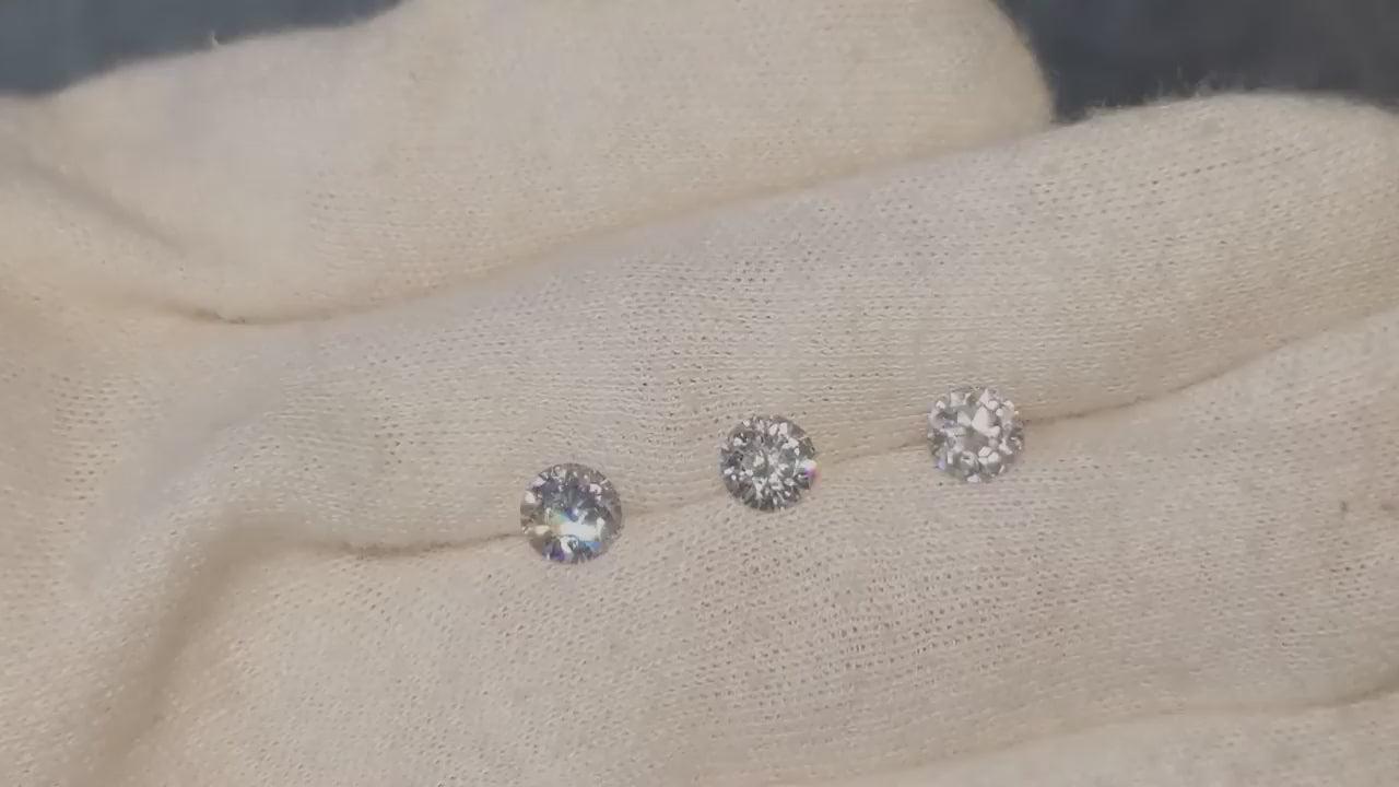 two mined diamonds and one lab grown diamonds on a white glove to see if people can tell the difference - Christine Sadler