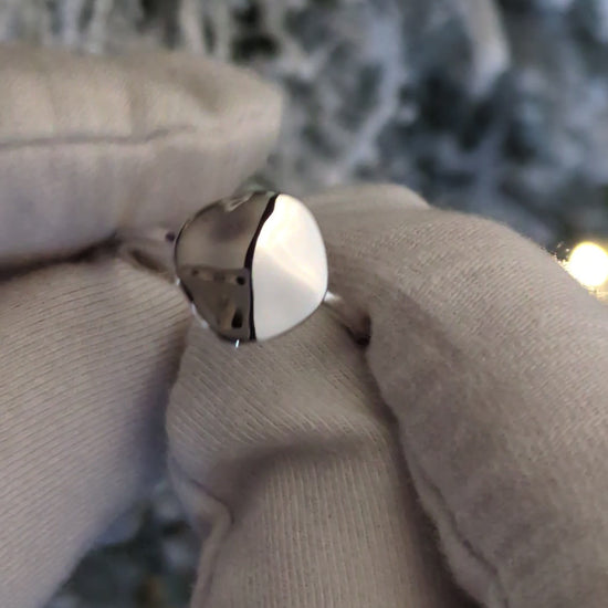 modern delicate designer silver ring that is highly polished