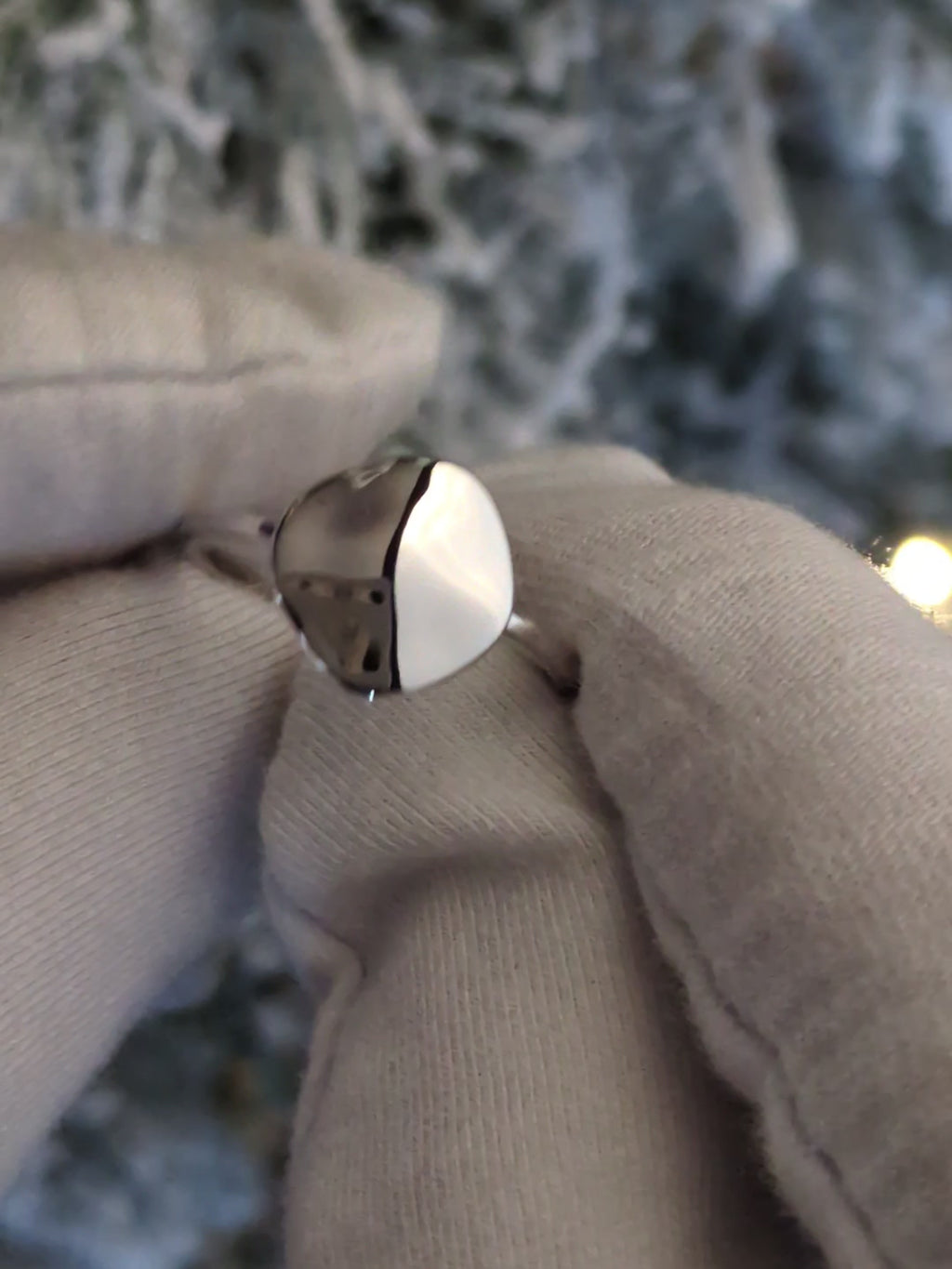 modern delicate designer silver ring that is highly polished