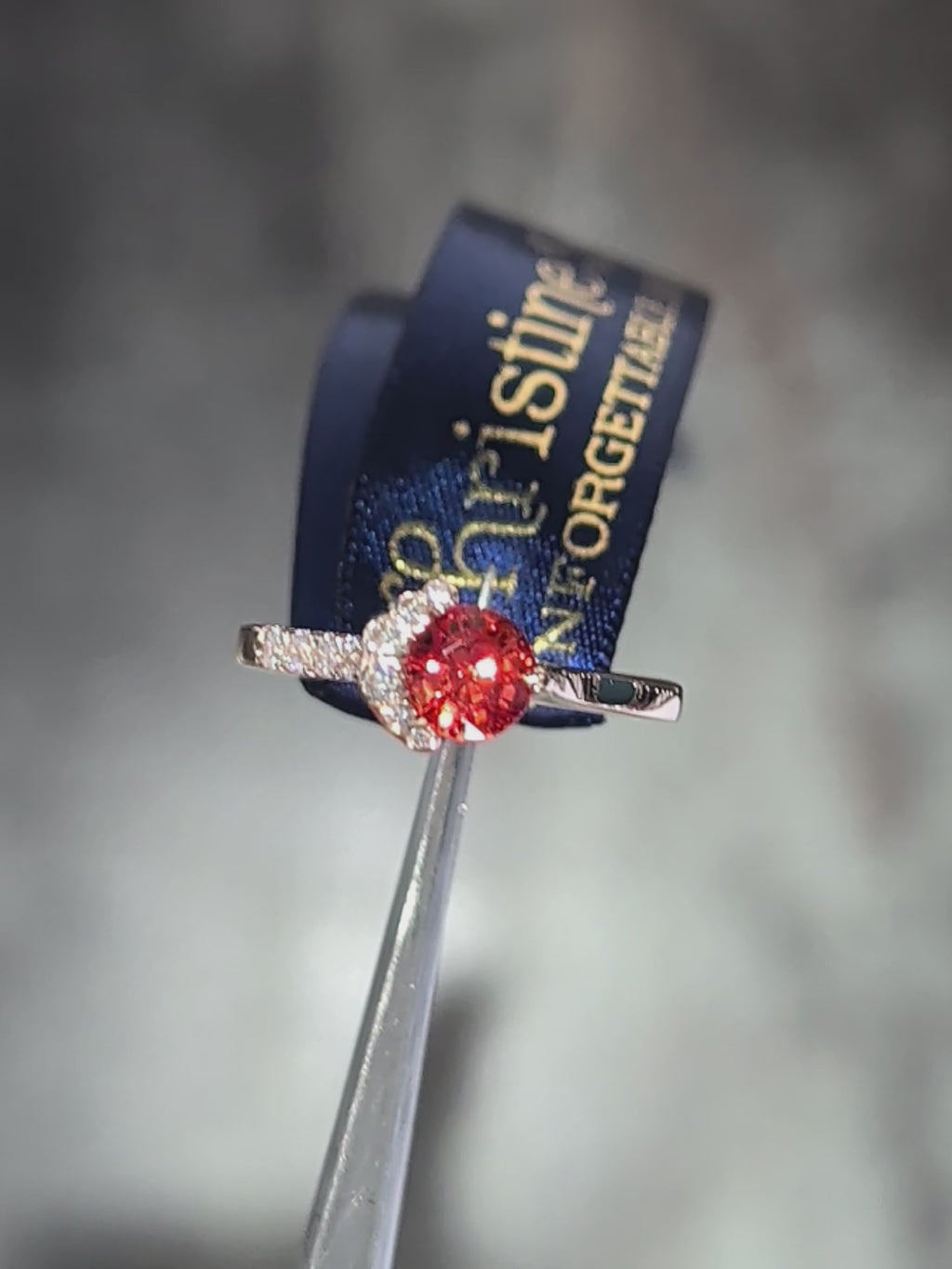 Close-up video of an orange sapphire and diamond ring in 18ct rose gold catching the light.
