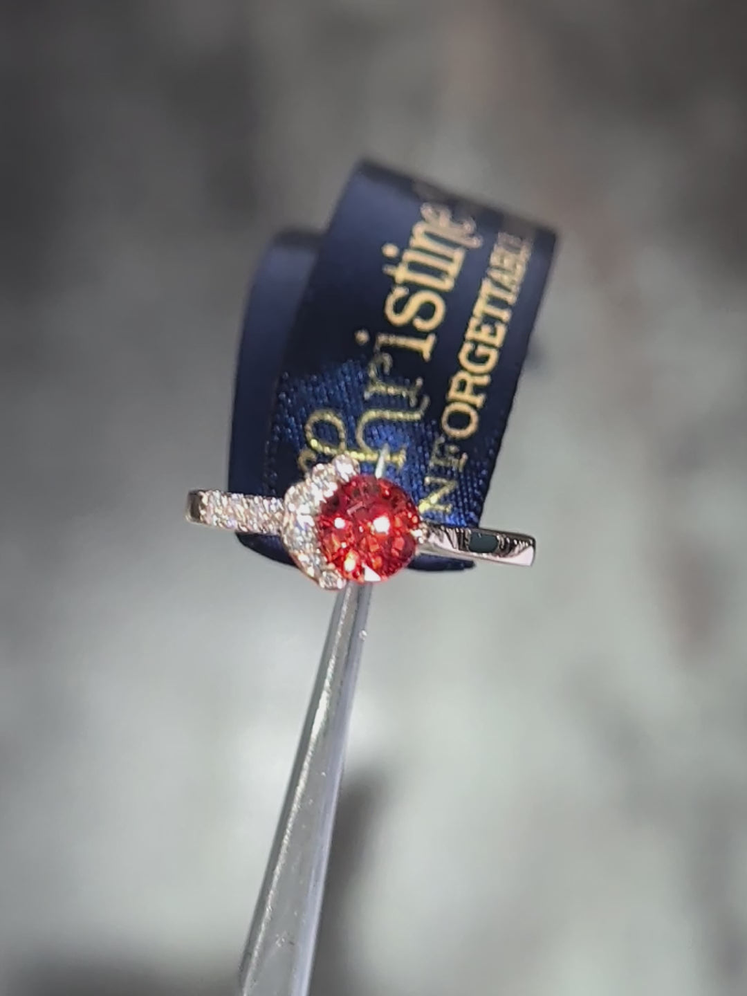 Close-up video of an orange sapphire and diamond ring in 18ct rose gold catching the light.