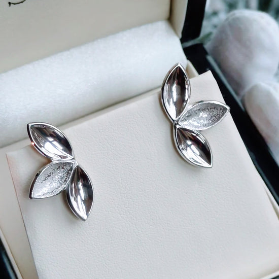 three almond shapes form an organic silver stud earring 