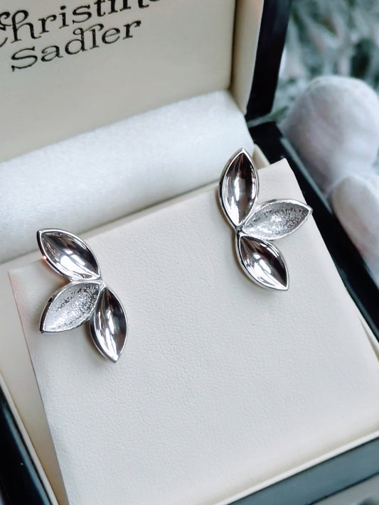 three almond shapes form an organic silver stud earring 