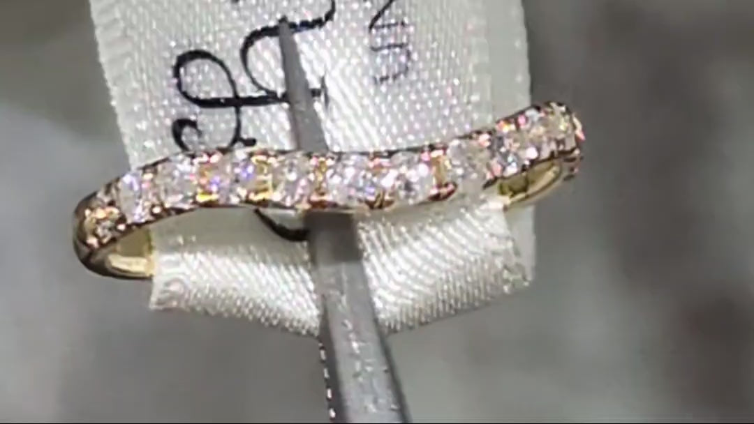 gold curved shaped wedding ring set with diamonds