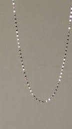 delicate platinum necklace that can be worn on its own and which sparkles when the light catches the polished links.