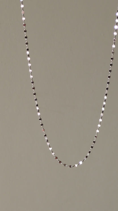 delicate platinum necklace that can be worn on its own and which sparkles when the light catches the polished links.