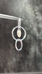 Demonstration video showing how to style the Jorge Revilla multi-way geometric gemstone silver hoop earrings with white pearls