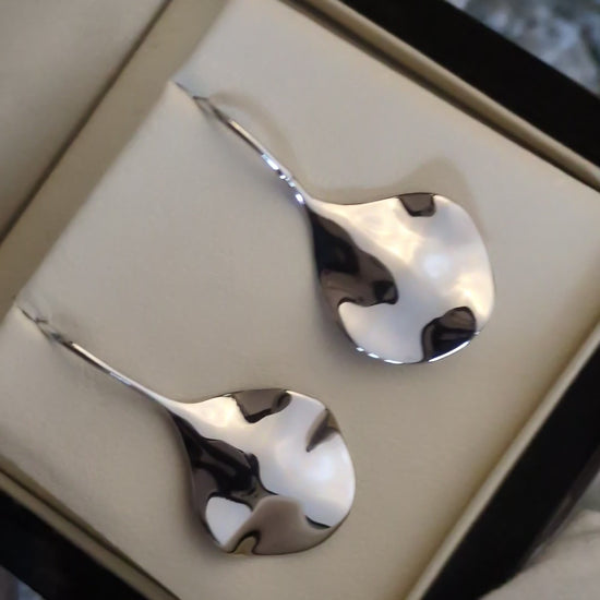 modern silver designer earrings that ripple like water by jewellery designer Jorge Revilla