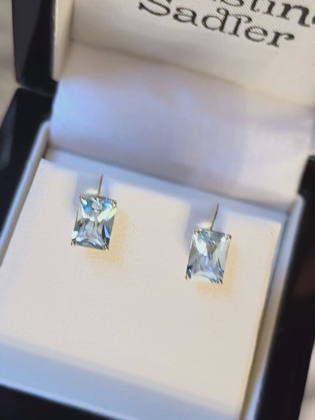 Radiant cut aquamarine gemstone earrings set in yellow gold.