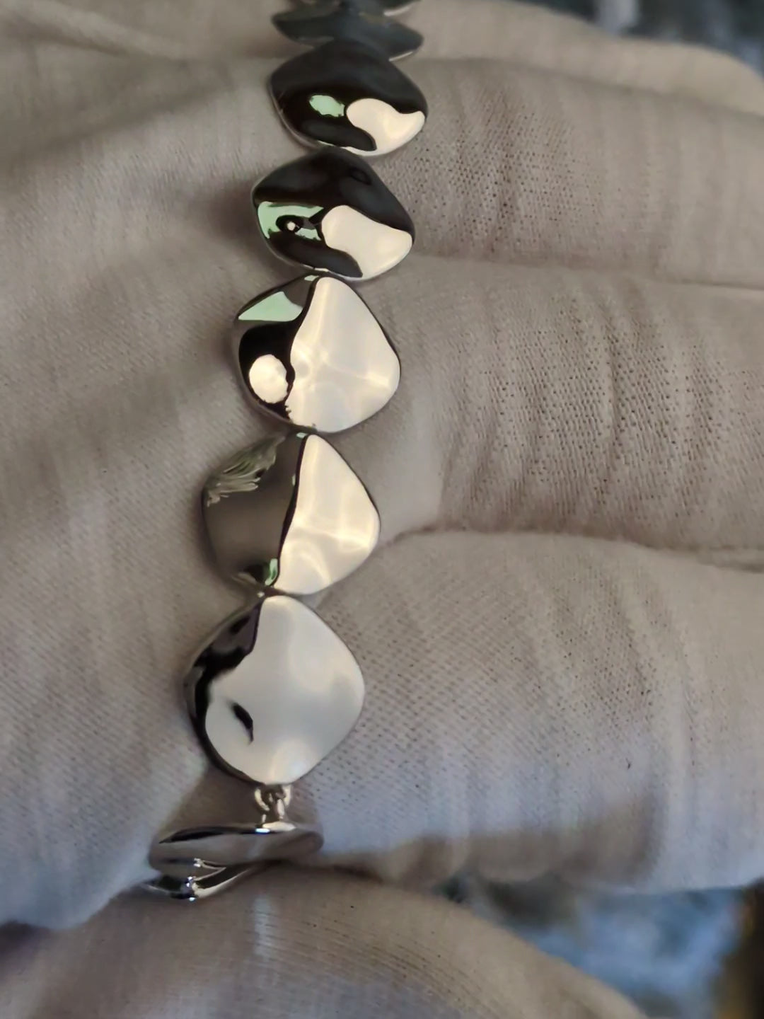 reflective highly polished silver bracelet that has lots of square links with rounded corners
