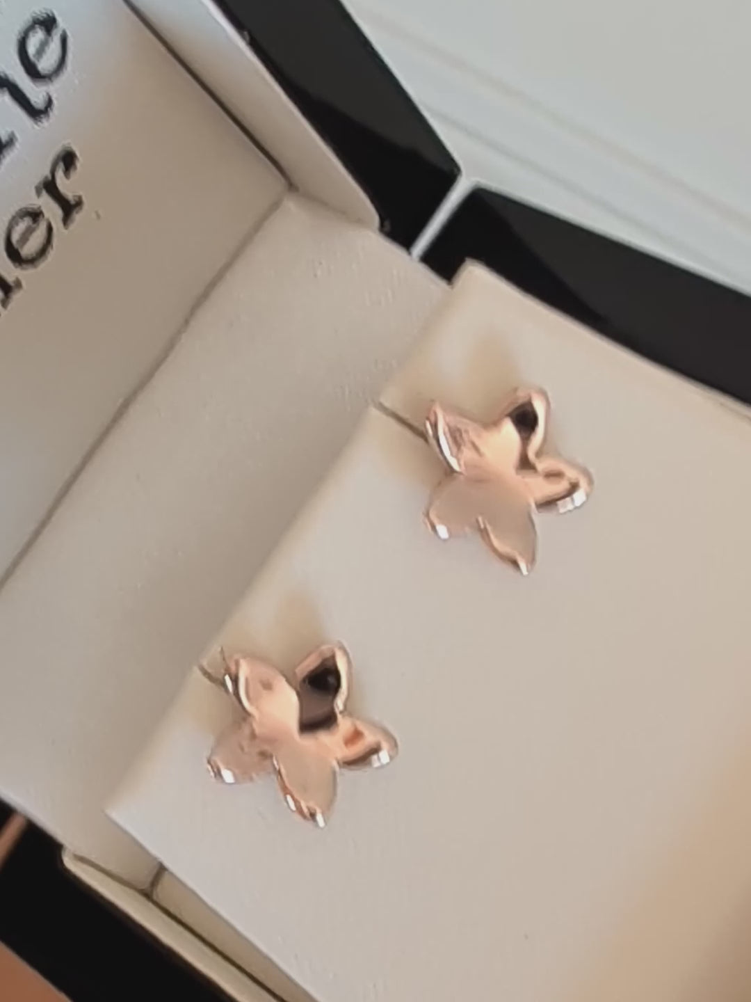 highly polished 9ct gold concave flower earrings, showing how they reflect the light.