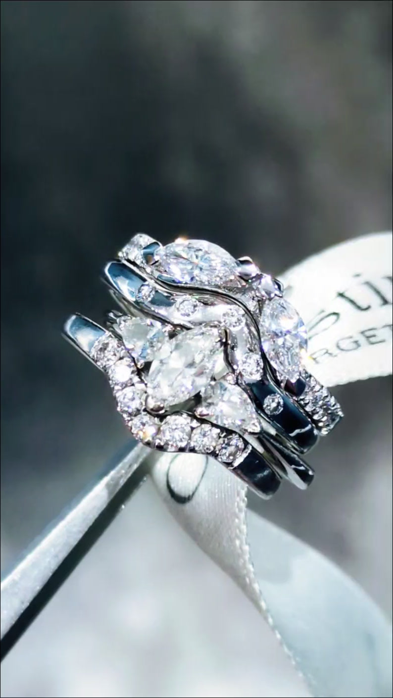 diamond and platinum engagement ring, wedding ring, eternity ring and forth ring together as a stacking bridal set. Christine Sadler