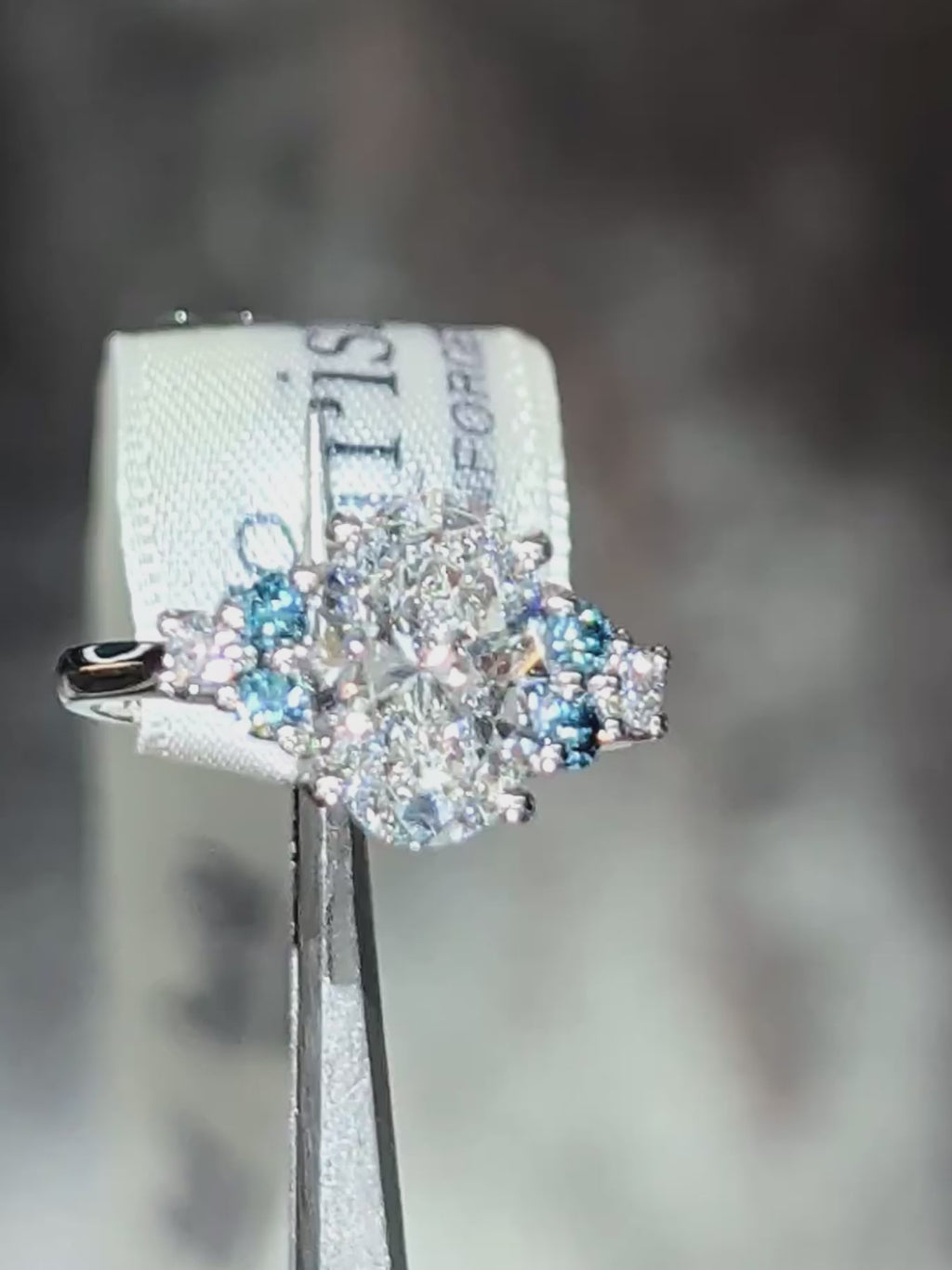Video of the Blue Sky Spark platinum ring, showing the oval lab diamond and blue lab diamond accents catching the light