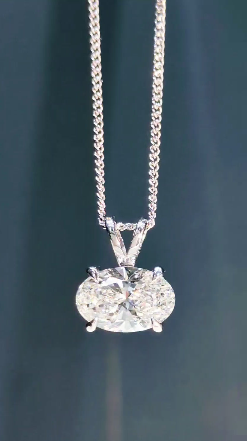 Video demonstrating the light performance and intense sparkle of an East-West 2-carat oval lab diamond pendant - Christine Sadler