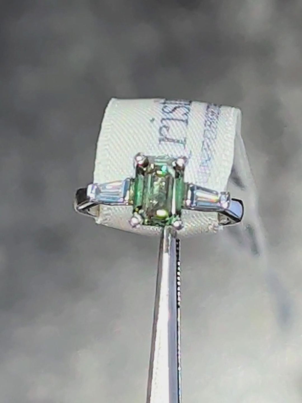 Fancy vivid emerald cut green certificated lab grown diamond platinum ring with two tapered white baguettes. One-of-a-kind. 