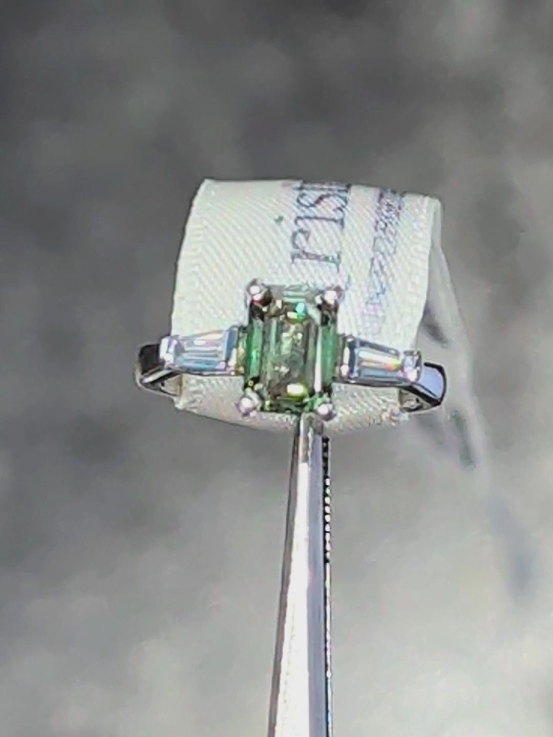 Fancy vivid emerald cut green certificated lab grown diamond platinum ring with two tapered white baguettes. One-of-a-kind. 