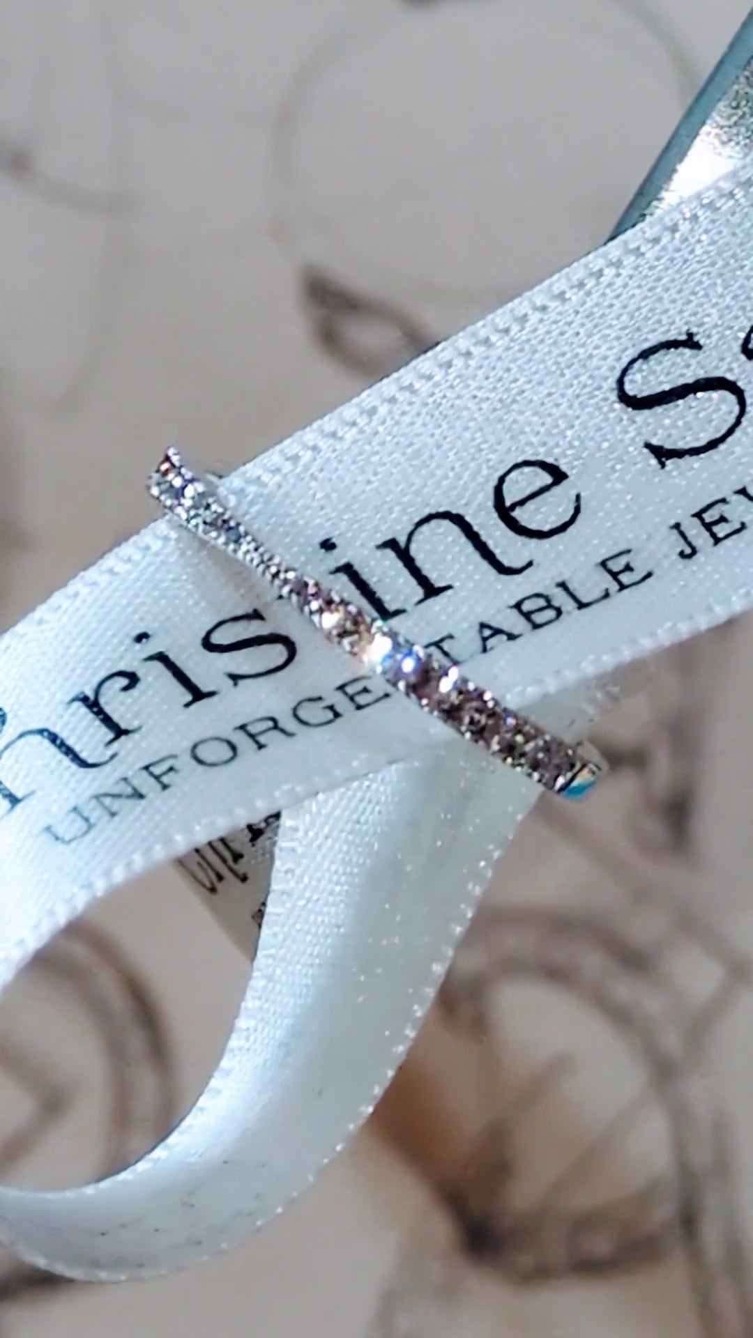 narrow diamond wedding ring for a woman in platinum with a pinched middle