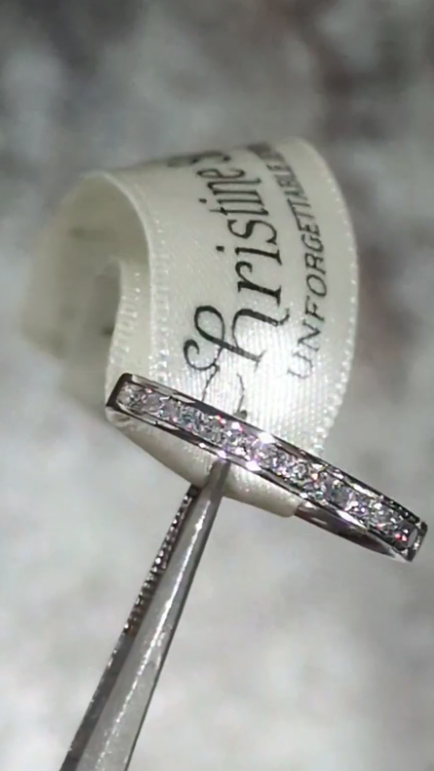 Platinum princess cut band channel set with diamonds half way round the band showing the sparkle from the stones and high quality precision setting - Christine Sadler