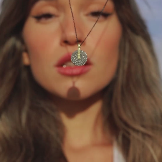 woman wearing Jorge Revilla Kymbal jewellery collection which is made of gold vermeil with black ruthenium