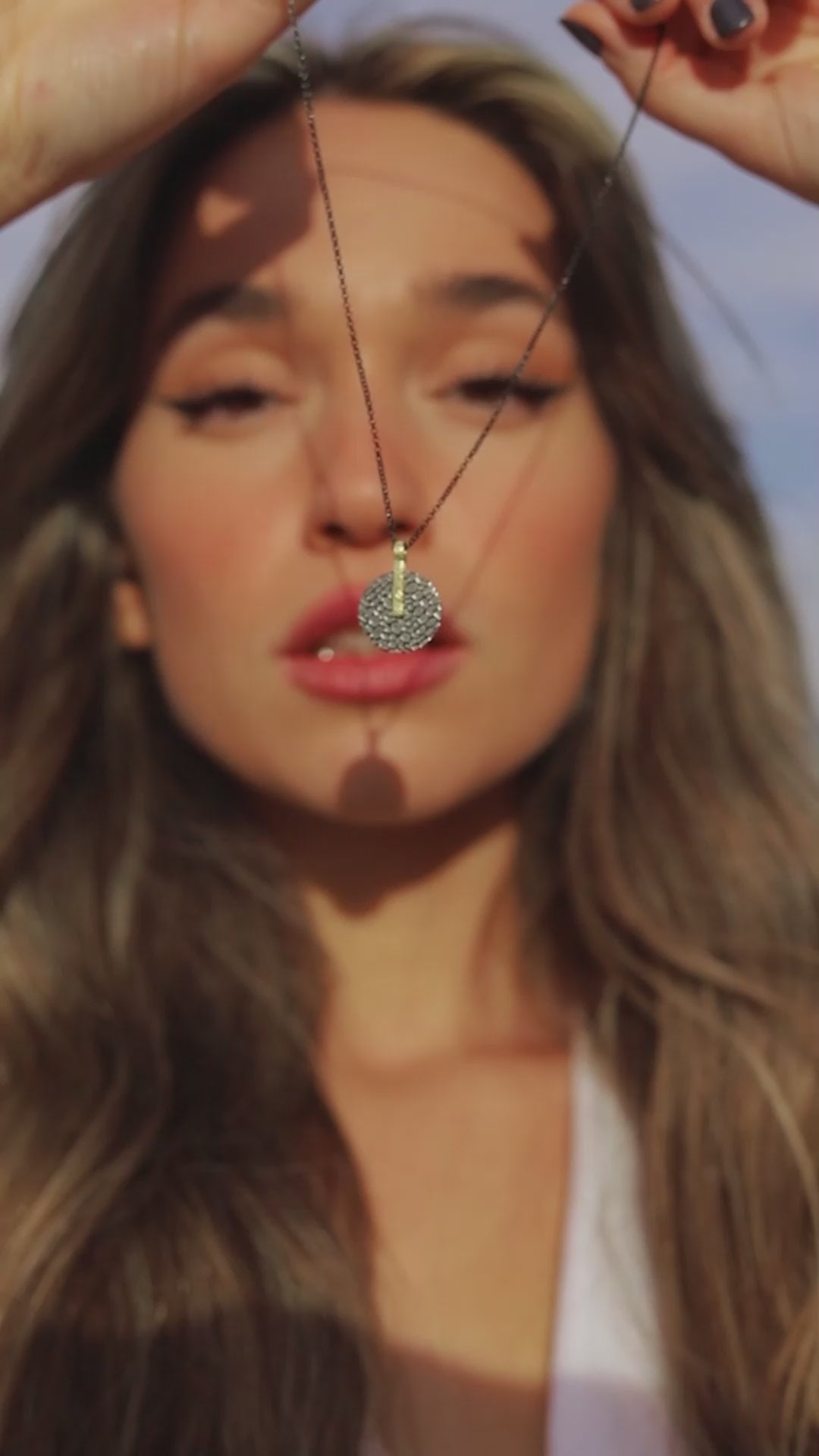 woman wearing Jorge Revilla Kymbal jewellery collection which is made of gold vermeil with black ruthenium
