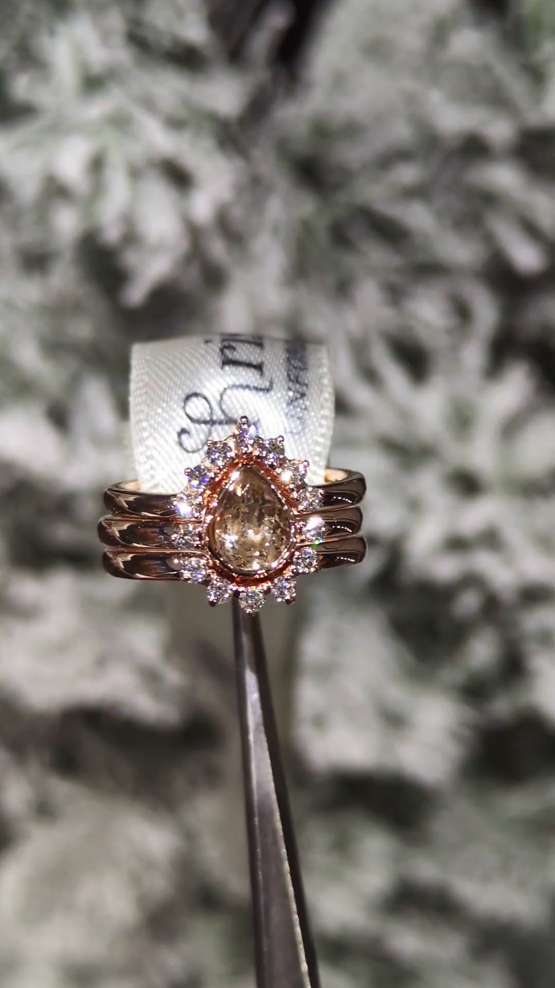 shaped diamond wedding ring and eternity ring around a pear cut morganite eternity ring to make a halo design when all three are combined