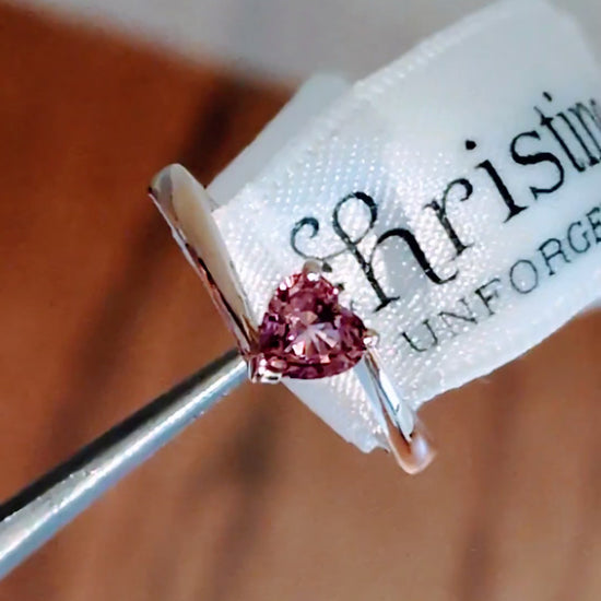 Pink sapphire heart cut gemstone in yellow gold twist ring